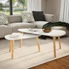 A living room scene with a sectional sofa, coffee tables, and a rug. Produktbild-Vorschau