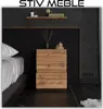 A bedroom scene featuring a nightstand next to a bed. Produktbild-Vorschau