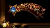A festive Christmas decoration shaped like a shooting star, illuminated by warm white LEDs, displayed in a window at night. Produktbild-Vorschau