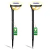 Two black solar garden lights with yellow light and green tags. Náhľad obrázku produktu