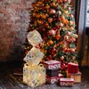 A stack of illuminated Christmas gift boxes in front of a decorated Christmas tree. Produktbild-Vorschau