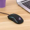 A gaming mouse is placed on a wooden desk next to a laptop. Produktbild-Vorschau