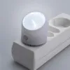 A white LED night light plugged into a white power strip. Anteprima dell’immagine prodotto