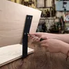 Hands assembling a wooden bench with a black metal backrest support. Produktbild-Vorschau