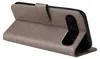 A gray flip case for a smartphone is shown in a side view, propped open to reveal the phone's camera. Produktbild-Vorschau