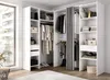 A white corner wardrobe with clothes and accessories inside, set up in a room with a large window. Produktbild-Vorschau