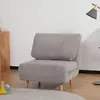 A gray sofa bed is shown in a room with a wooden cabinet and a lamp. Náhled obrázku produktu