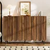 A wooden sideboard with a decorative wave pattern on its doors, placed in a well-lit room with decorative items on top. Voir les images du produit