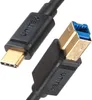 A close-up shot of a USB-C to USB-B 3.0 cable, showing both connectors. Náhled obrázku produktu