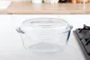 A clear glass casserole dish with a lid sits on a countertop in a kitchen setting. Náhľad obrázku produktu