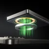 A close-up illustration showing a magnetic charging connection between two devices, with green energy lines indicating power transfer. Produktbild-Vorschau