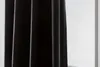 A close-up view of a black curtain with vertical folds, set against a white background. Produktbild-Vorschau