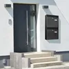 A modern house entrance with a dark gray door, a window, and a black double mailbox mounted on the white textured wall. Produktbild-Vorschau