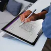 A person is using a stylus to draw on a tablet computer. Anteprima dell’immagine prodotto