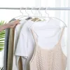 Clothes hanging on hangers on a rack. Produktbild-Vorschau