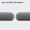 Two grey Beats Pill speakers are shown side-by-side against a white background. Podgląd zdjęcia produktu
