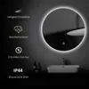 A round LED mirror with integrated lighting is displayed in a modern bathroom setting, above a sink. Voir les images du produit