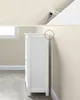 A white cabinet is shown next to a wall, with a close-up view of an anti-tip bracket on the top of the cabinet and wall. Náhled obrázku produktu