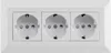 A white triple electrical socket outlet mounted on a white surface. Produktbild-Vorschau