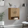 A wall-mounted cabinet with two doors and an open shelf below, decorated with a plant and a clock. Voir les images du produit