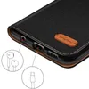 Close-up view of the bottom edge of a black flip phone case, showing ports and a leather tag with a logo. Anteprima dell’immagine prodotto
