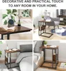 Collage of four images showing a dark wood and black metal side table in different settings: next to a bed, next to a chair, and on a desk. Produktbild-Vorschau
