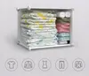 A white modular storage unit filled with folded clothes and rolled items. Anteprima dell’immagine prodotto