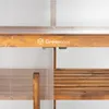 Close-up of a wooden and polycarbonate mini greenhouse, showing the brand logo and a shelf. Voir les images du produit