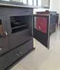 A close-up view of a kitchen stove with its door open, revealing an interior oven space with a pan inside. Another stove is visible in the background. Produktbild-Vorschau