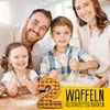 A family is in a kitchen, seemingly preparing to bake waffles. The children are smiling and engaged in the activity, while the parents look on happily. A waffle shaped like the number '2' is prominently displayed in the foreground, along with text overlay. Produktbild-Vorschau