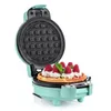 An open aqua colored waffle maker with a finished waffle topped with whipped cream and raspberries. Podgląd zdjęcia produktu