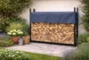 A firewood rack with a cover in a garden setting. Produktbild-Vorschau