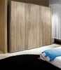 A modern sliding door wardrobe with a wood-effect finish. Produktbild-Vorschau