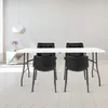 A white folding table with four black chairs in a minimalist room. Náhľad obrázku produktu