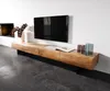 A modern living room with a wall-mounted TV and a wooden media console. Produktbild-Vorschau