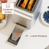 A close-up view of a stainless steel toaster with toast inside, and its crumb tray extended. Produktbild-Vorschau
