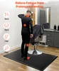 A man stands on an anti-fatigue mat in what appears to be a salon or barbershop, with red dots highlighting areas of fatigue on his body. Podgląd zdjęcia produktu