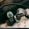 Close-up of two in-ear monitor headphones with a black cable. Produktbild-Vorschau