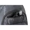 A close-up view of a black and gray camouflage backpack with sunglasses in a zippered pocket. Produktbild-Vorschau