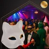 A group of people at a party, with a cat mask in the foreground. Náhled obrázku produktu