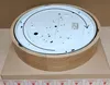 The underside of a round wooden ceiling lamp is shown, resting on a cardboard box. Produktbild-Vorschau