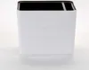 A white planter with horizontal ridges and a black top rim, set against a light gray and white background. Náhled obrázku produktu