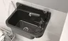 A black granite sink with a silver faucet mounted on a tiled wall. Produktbild-Vorschau