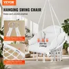 A white hanging swing chair with a cushion, suspended indoors with plants in the background. Podgląd zdjęcia produktu