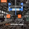 A product image showing a trolley mechanism with text overlays and icons, set against a blurred industrial background of metal beams. Náhľad obrázku produktu