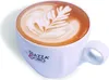 A close-up shot of a white coffee cup filled with latte art. Náhled obrázku produktu