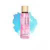 A bottle of Victoria's Secret Velvet Petals fragrance mist is shown against a watercolor-like background. Podgląd zdjęcia produktu