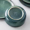 The underside of a green ceramic bowl with brand markings and symbols. Náhled obrázku produktu