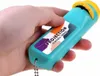 A hand holding a teal and yellow projection electric torch. Náhled obrázku produktu