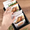 A hand is reaching into a black organizer filled with spice packets. Náhľad obrázku produktu